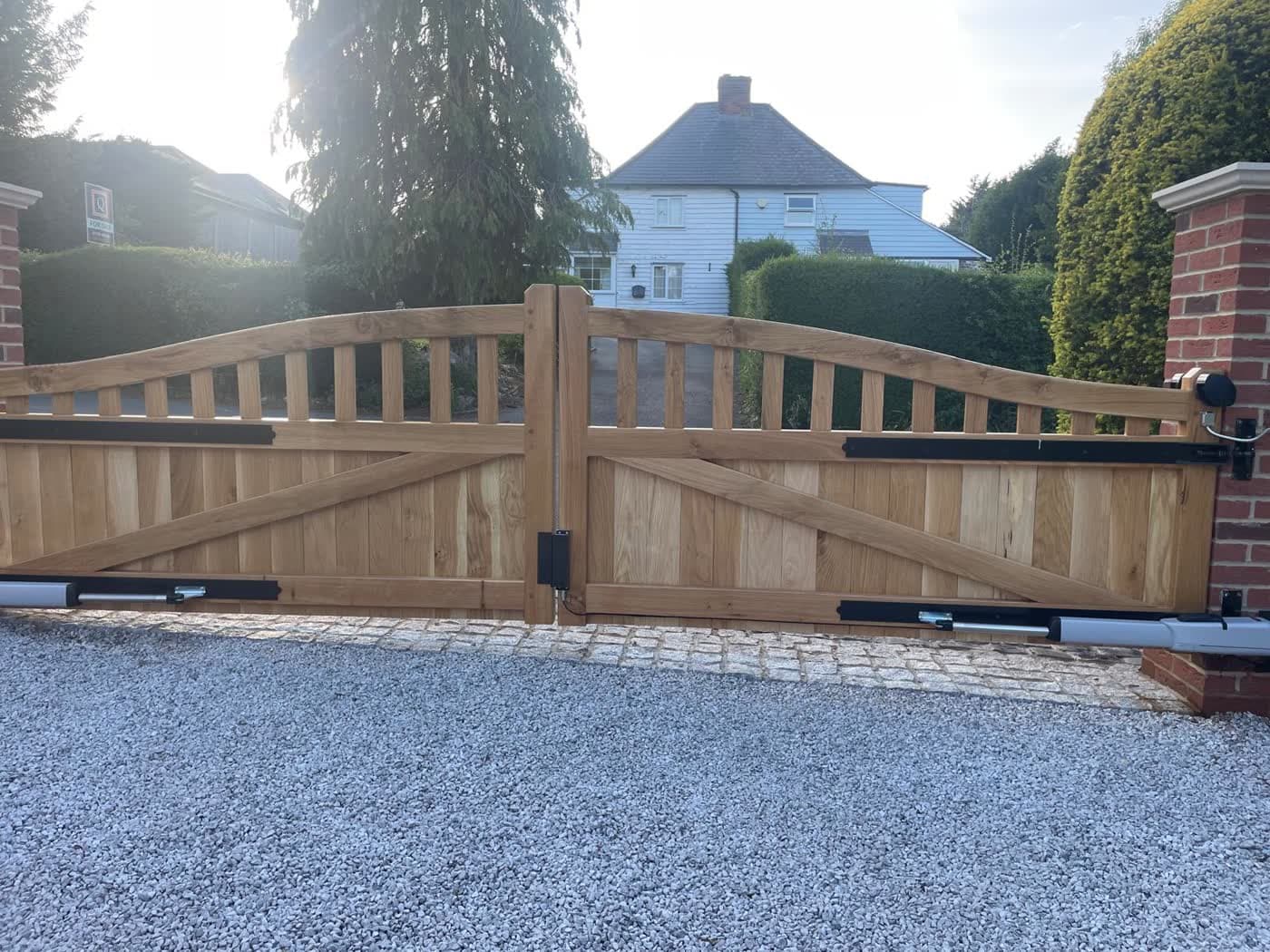 Oak double swing gate fitted with ram actuators on a Kent driveway